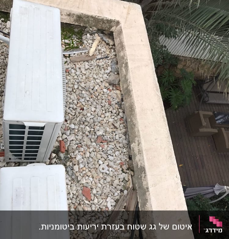 אבנים קטנות על גג עם יחידות מיזוג אוויר